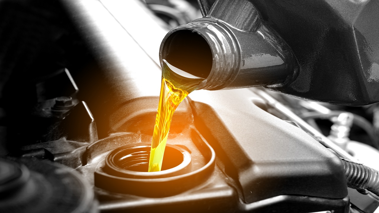 Car Oil Change, Pouring Oil Into Engine, Car Transmission and Maintenance Gear